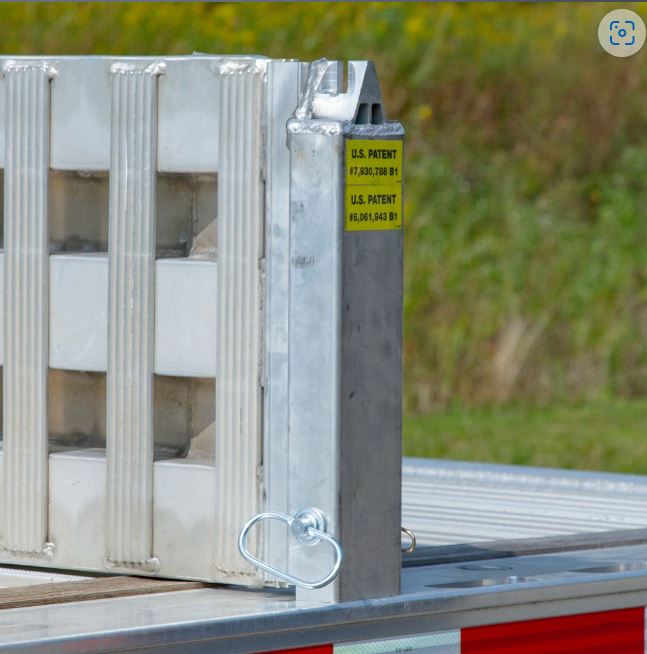 Right-side aluminum load leveler stake measuring 4-1/8 inches long, 4-1/8 inches wide, and 18-1/4 inches high; weighs 10 lbs and fits 3/8-inch chain for securing step deck trailer ramps.